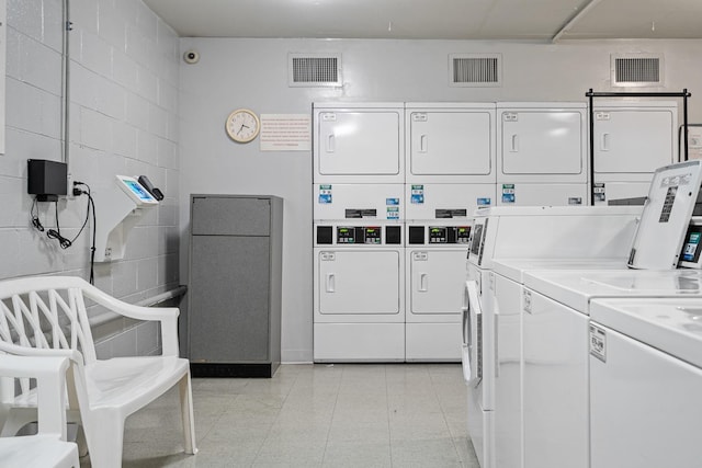 33 E Cedar St Unit 6B, Chicago, IL 60611 - community laundry featuring estacked washer and dryer, washer and dryer, and concrete block wall