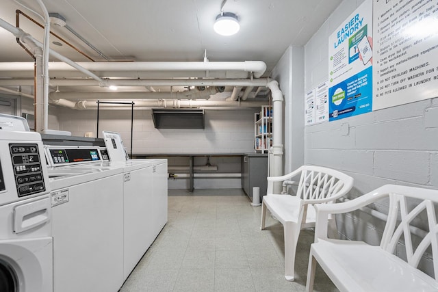 33 E Cedar St Unit 6B, Chicago, IL 60611 - shared laundry room featuring washing machine and clothes dryer and concrete block wall