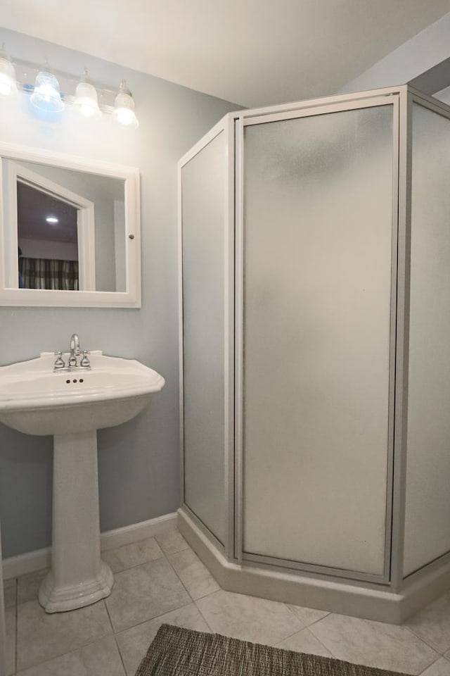 1024 Lakestone Ln, Aurora, IL 60504 - full bathroom featuring a stall shower, baseboards, tile patterned floors, and a sink