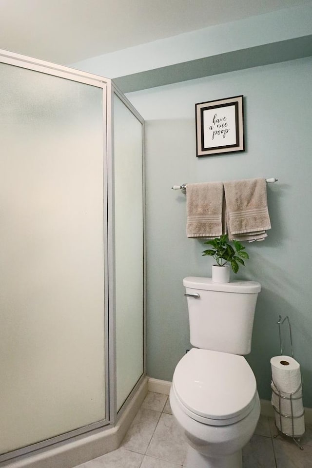 1024 Lakestone Ln, Aurora, IL 60504 - bathroom featuring marble look tiles, a stall shower, toilet, and baseboards