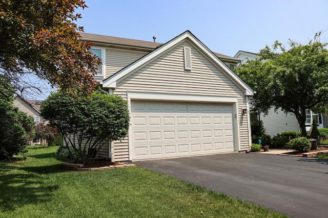 1024 Lakestone Ln, Aurora, IL 60504 - view of front of house with asphalt driveway, a front yard, and an attached garage