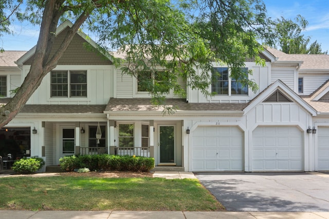 211 Spring Point Dr, Carpentersville, IL 60110 - townhome / multi-family property featuring board and batten siding, covered porch, asphalt driveway, and a shingled roof