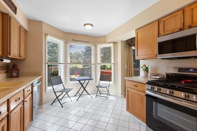 211 Spring Point Dr, Carpentersville, IL 60110 - kitchen featuring appliances with stainless steel finishes, light countertops, and light tile patterned floors