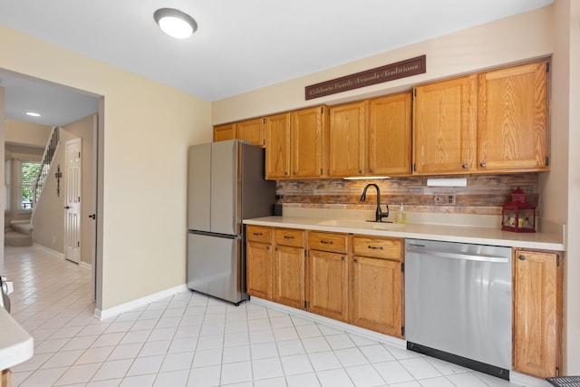 211 Spring Point Dr, Carpentersville, IL 60110 - kitchen featuring appliances with stainless steel finishes, decorative backsplash, light countertops, light tile patterned flooring, and brown cabinetry