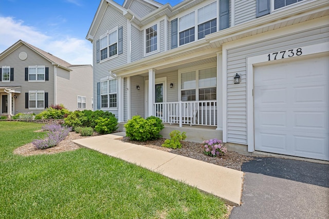17738 S Willard Ln, Lockport, IL 60441 - view of front facade featuring a porch, a garage, and a front yard