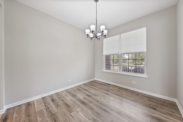 17738 S Willard Ln, Lockport, IL 60441 - unfurnished room with a chandelier, baseboards, and wood finished floors
