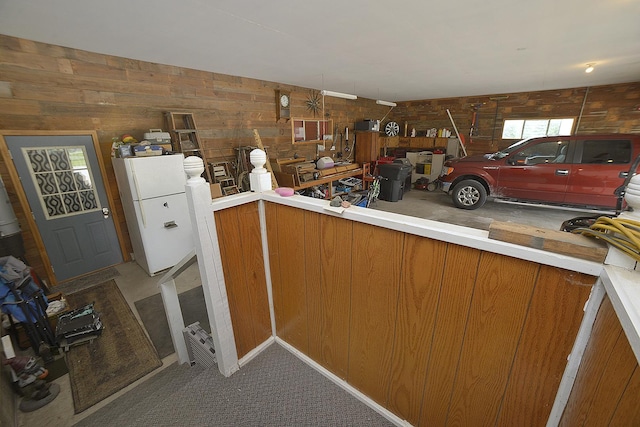 2098 N 15th Rd, Streator, IL 61364 - kitchen featuring freestanding refrigerator, brown cabinetry, wooden walls, and carpet floors