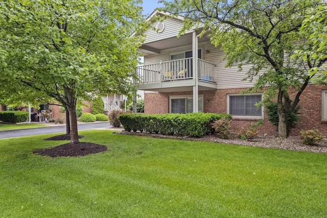 9810 Parkway Dr None, Unit None, Highland, IN 46322 - view of side of home featuring a lawn, brick siding, and a balcony