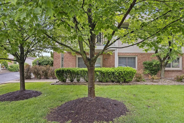 9810 Parkway Dr None, Unit None, Highland, IN 46322 - view of property hidden behind natural elements featuring a front yard and brick siding