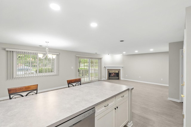 9810 Parkway Dr None, Unit None, Highland, IN 46322 - kitchen with white cabinetry, recessed lighting, a chandelier, decorative light fixtures, and baseboards