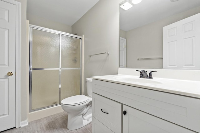 9810 Parkway Dr None, Unit None, Highland, IN 46322 - full bathroom featuring toilet, vanity, a stall shower, and wood finished floors