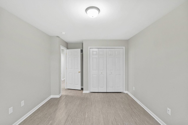 9810 Parkway Dr None, Unit None, Highland, IN 46322 - unfurnished bedroom with baseboards, wood finished floors, and a closet
