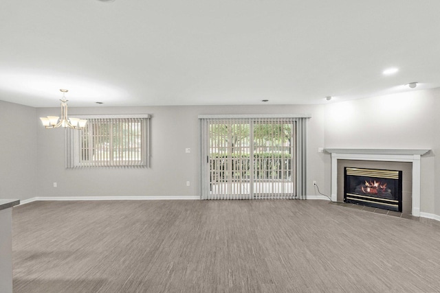 9810 Parkway Dr None, Unit None, Highland, IN 46322 - unfurnished living room with a chandelier, a fireplace, wood finished floors, and baseboards
