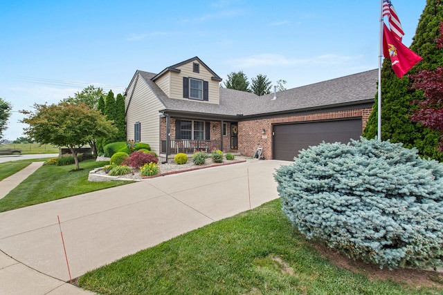 2910 Greystone Pl, Champaign, IL 61822 - view of front facade with a porch, brick siding, concrete driveway, a front lawn, and a garage