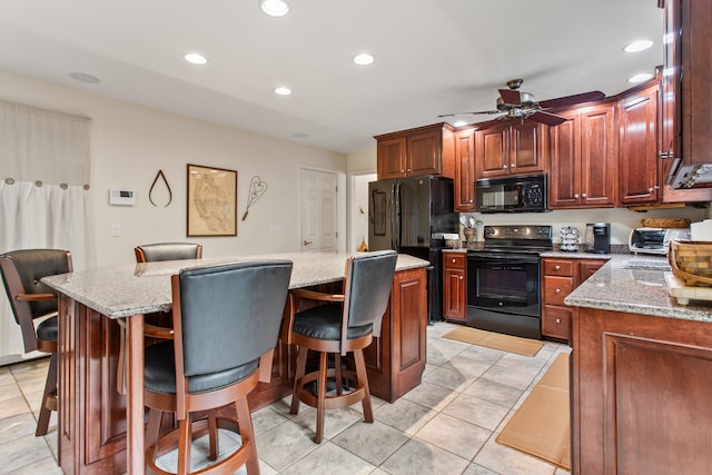 2910 Greystone Pl, Champaign, IL 61822 - kitchen with black appliances, a ceiling fan, a kitchen breakfast bar, recessed lighting, and light stone countertops