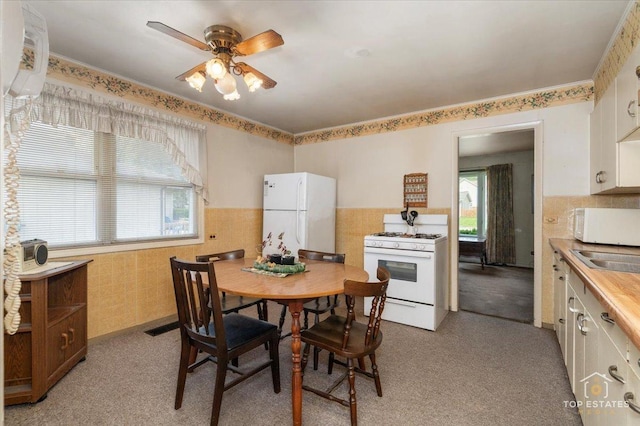 3604 Owl Dr, Rolling Meadows, IL 60008 - dining space with ceiling fan, light colored carpet, and a wainscoted wall