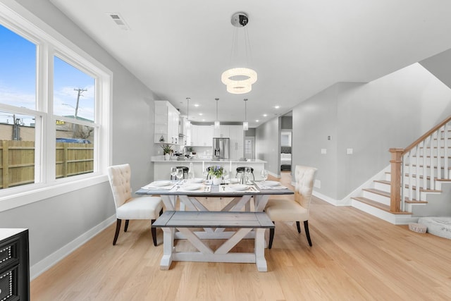 4113 Eberly Ave, Brookfield, IL 60513 - dining space with baseboards, light wood-type flooring, stairs, recessed lighting, and a chandelier