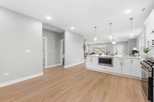 4113 Eberly Ave, Brookfield, IL 60513 - kitchen featuring a peninsula, stainless steel gas stove, built in microwave, white cabinetry, and light wood-style flooring