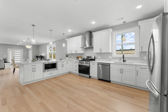 4113 Eberly Ave, Brookfield, IL 60513 - kitchen with stainless steel appliances, wall chimney exhaust hood, a peninsula, a sink, and open floor plan