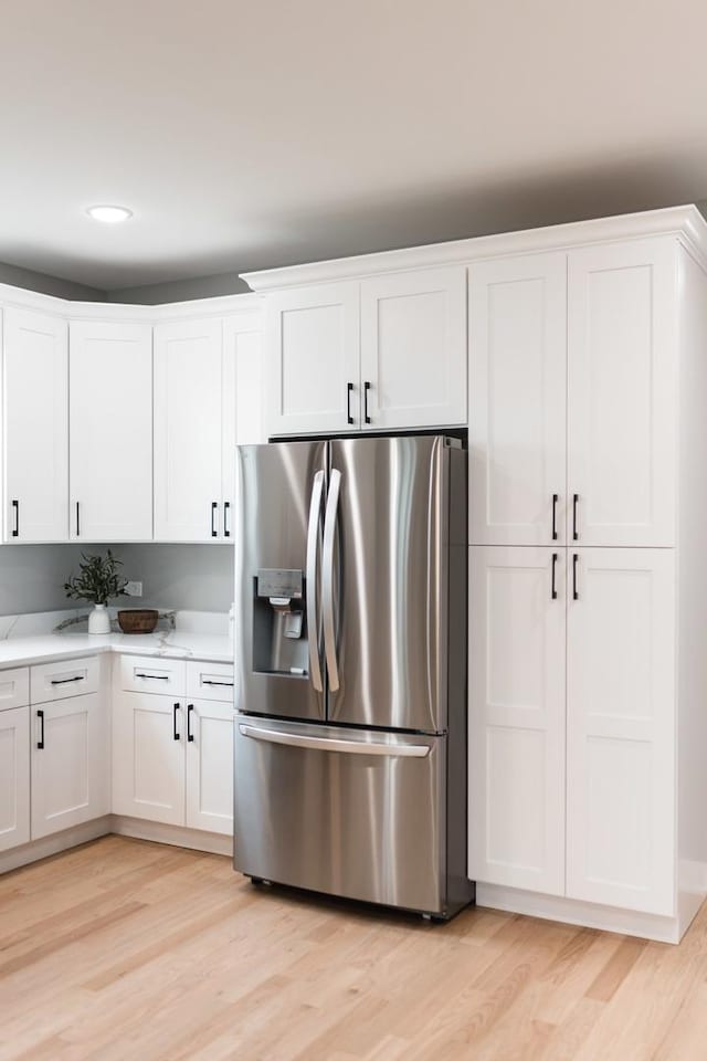 4113 Eberly Ave, Brookfield, IL 60513 - kitchen with stainless steel fridge, white cabinets, light wood-style floors, and recessed lighting