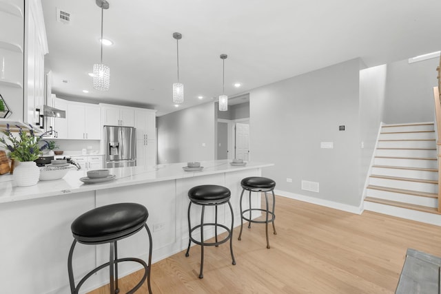 4113 Eberly Ave, Brookfield, IL 60513 - kitchen featuring stainless steel fridge, a peninsula, light wood-style floors, white cabinetry, and recessed lighting