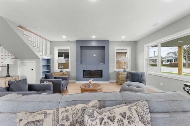 4113 Eberly Ave, Brookfield, IL 60513 - living area with baseboards, stairs, wood finished floors, recessed lighting, and a large fireplace