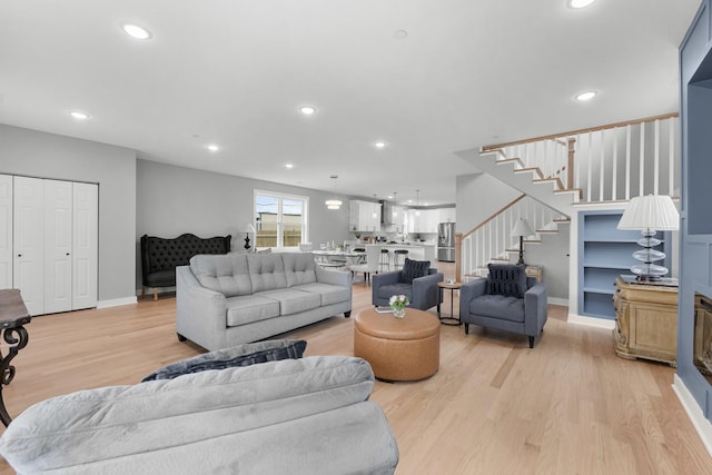 4113 Eberly Ave, Brookfield, IL 60513 - living room with light wood finished floors, stairway, recessed lighting, and baseboards