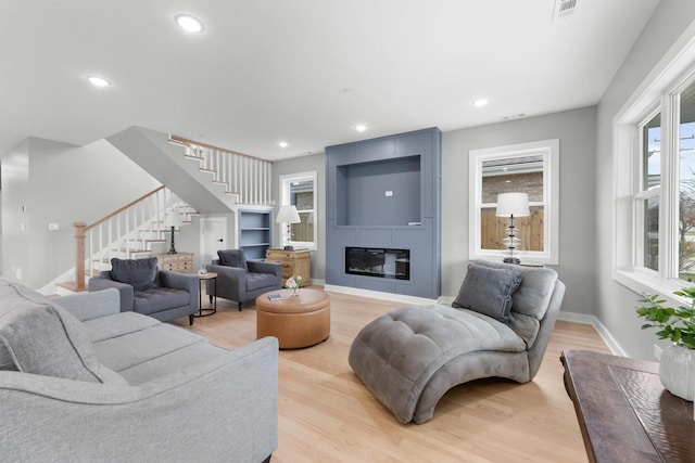 4113 Eberly Ave, Brookfield, IL 60513 - living area with stairs, baseboards, light wood-style floors, recessed lighting, and a fireplace