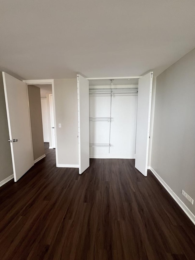 2626 N Lakeview Ave Unit 1509, Chicago, IL 60614 - unfurnished bedroom featuring dark wood-style floors, baseboards, and a closet