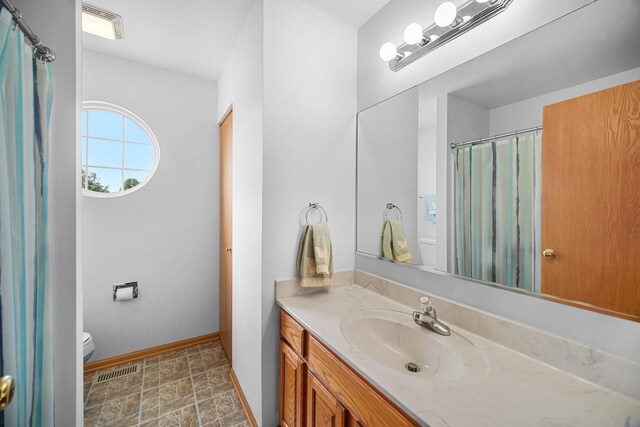 2802 Forestview Dr, Carpentersville, IL 60110 - full bath with toilet, vanity, baseboards, stone finish flooring, and a shower with curtain