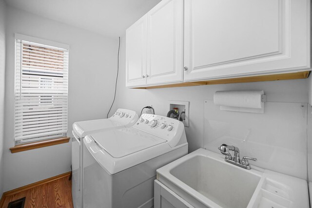 2802 Forestview Dr, Carpentersville, IL 60110 - laundry area featuring washing machine and dryer, cabinet space, and wood finished floors