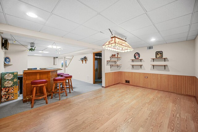 2802 Forestview Dr, Carpentersville, IL 60110 - indoor dry bar with a paneled ceiling, wood finished floors, a wainscoted wall, and wood walls
