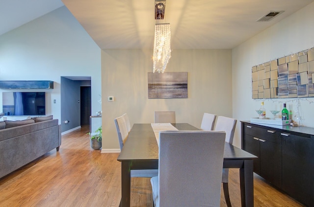 14121 Norwich Ln Unit 301, Orland Park, IL 60467 - dining space featuring a chandelier, light wood-style flooring, and baseboards