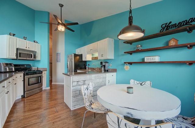 14121 Norwich Ln Unit 301, Orland Park, IL 60467 - kitchen featuring stainless steel appliances, a ceiling fan, a high ceiling, open shelves, and white cabinets