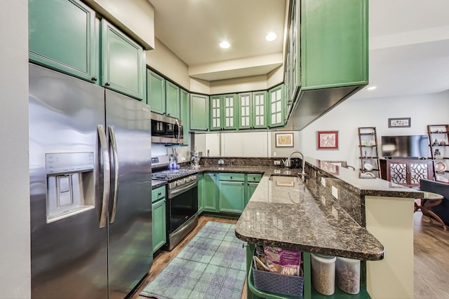888 S Michigan Ave Unit 601, Chicago, IL 60605 - kitchen with appliances with stainless steel finishes, green cabinetry, a peninsula, dark stone countertops, and recessed lighting