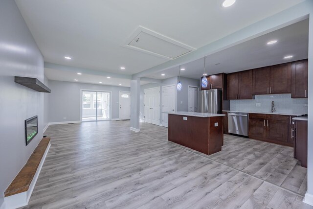 620 Ashland St, Hoffman Estates, IL 60169 - kitchen with stainless steel appliances, a kitchen island, open floor plan, light countertops, and light wood-style flooring