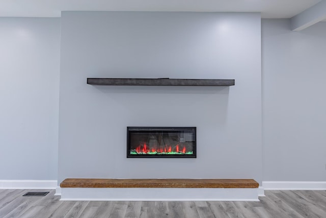 620 Ashland St, Hoffman Estates, IL 60169 - detailed view of wood finished floors, a glass covered fireplace, and baseboards