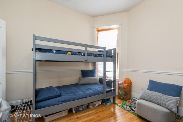3540 S Prairie Ave Unit 1, Chicago, IL 60653 - bedroom featuring multiple windows, wood finished floors, and baseboards