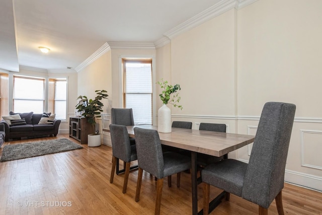 3540 S Prairie Ave Unit 1, Chicago, IL 60653 - dining room with ornamental molding, light wood-style flooring, a wainscoted wall, and a decorative wall