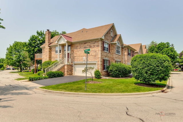 1296 Ashley Ct, Vernon Hills, IL 60061 - view of front facade featuring asphalt driveway, a garage, a chimney, brick siding, and a front lawn