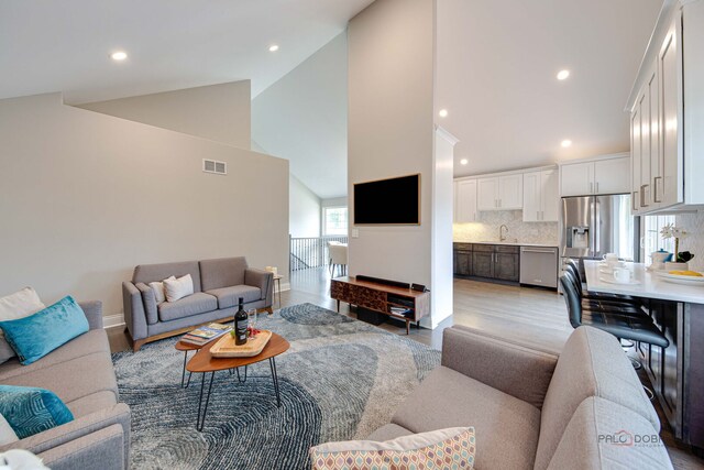 1296 Ashley Ct, Vernon Hills, IL 60061 - living area with high vaulted ceiling, light wood finished floors, and recessed lighting