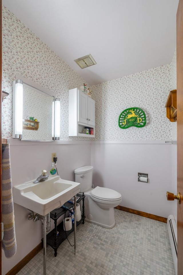 321 Cartwright Ln, Oregon, IL 61061 - bathroom featuring baseboard heating, wallpapered walls, toilet, and baseboards