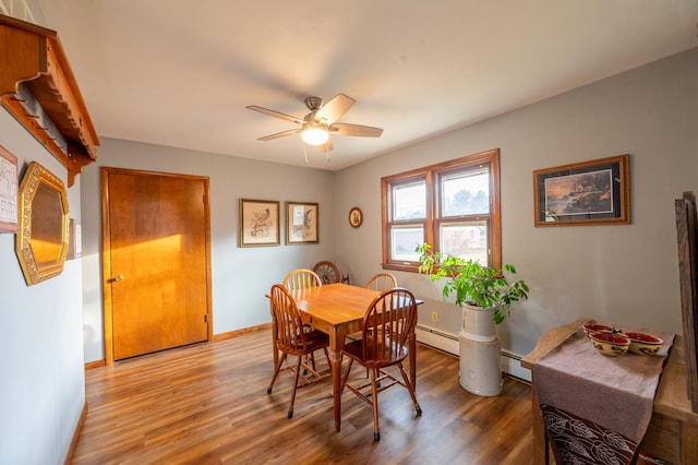 321 Cartwright Ln, Oregon, IL 61061 - dining room featuring ceiling fan, light wood-style flooring, baseboards, and a baseboard heating unit
