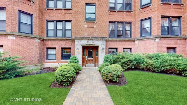 1114 W Pratt Blvd Unit 3S, Chicago, IL 60626 - view of front facade with a front lawn and brick siding