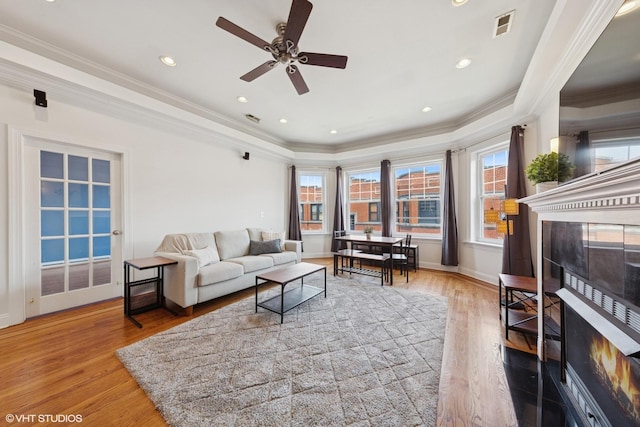 1114 W Pratt Blvd Unit 3S, Chicago, IL 60626 - living room featuring a warm lit fireplace, wood finished floors, ornamental molding, a ceiling fan, and recessed lighting
