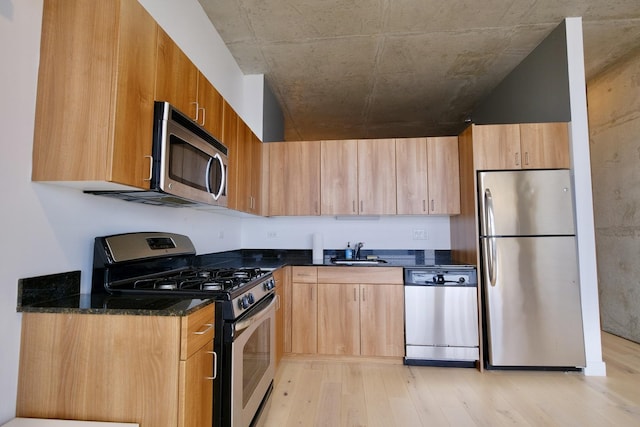 235 W Van Buren St Unit 4206, Chicago, IL 60607 - kitchen with stainless steel appliances, a sink, light wood-style floors, dark stone counters, and modern cabinets
