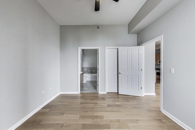 1464 S Michigan Ave Unit 1404, Chicago, IL 60605 - unfurnished bedroom featuring light wood finished floors, connected bathroom, and a ceiling fan