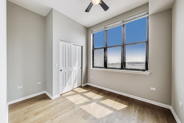 1464 S Michigan Ave Unit 1404, Chicago, IL 60605 - unfurnished bedroom with wood finished floors, a closet, and a ceiling fan