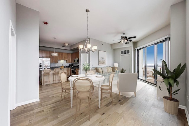 1464 S Michigan Ave Unit 1404, Chicago, IL 60605 - dining room featuring light wood-style flooring, a ceiling fan, and a chandelier