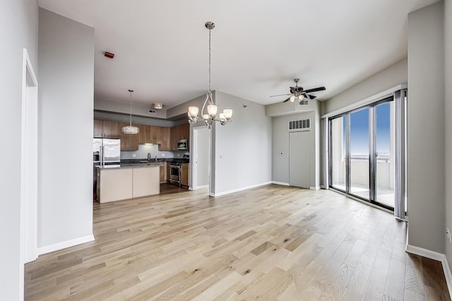 1464 S Michigan Ave Unit 1404, Chicago, IL 60605 - kitchen featuring open floor plan, appliances with stainless steel finishes, a ceiling fan, a chandelier, and light wood finished floors